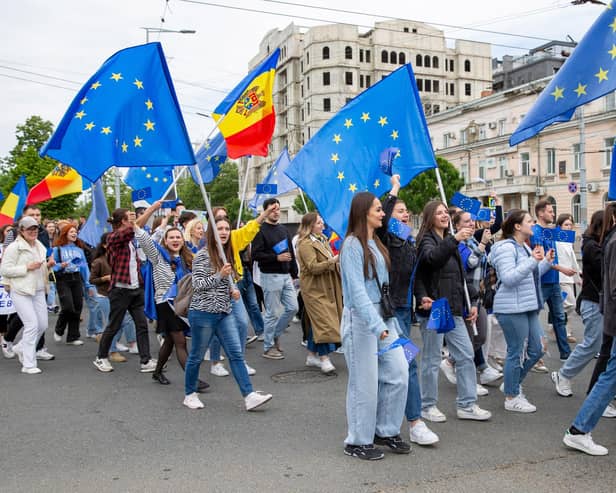 Young Moldovans waving EU and Moldovan flags take part in a march in Chisinau to celebrate Europe Day. Picture: Elena Covalenco/AFP