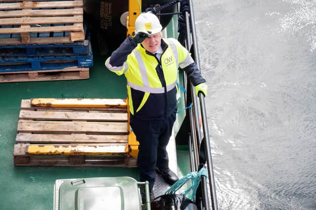 Boris Johnson gestures onboard the Esvagt Alba during a visit to the Moray Offshore Windfarm East
