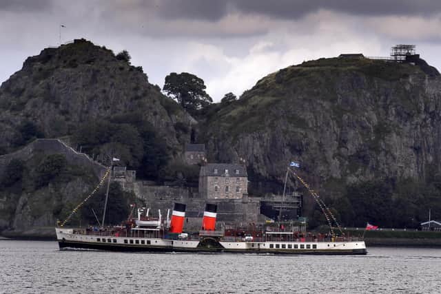 GLASGOW, SCOTLAND - AUGUST 22: The Waverley paddle steamer passes Dumbarton Rock as it returns to sailing on the Clyde following a successful campaign to raise £2.3 million for new boilers to keep the 73-year-old vessel in operation on August 22, 2020 in Glasgow, Scotland. The ship, described as the world's last seagoing paddle steamer was built just after World War Two, as a replacement for a vessel sunk during the Dunkirk evacuation. (Photo by Jeff J Mitchell/Getty Images)