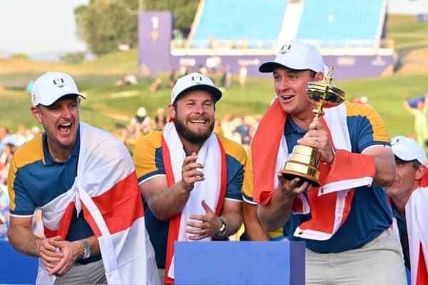 Austrian Sepp Straka lifts the Ryder Cup watched by two of his team-mates, Justin Rose and Tyrrell Hatton, after Europe's victory at Marco Simone Golf and Country Club in Rome. Picture: Andreas Solaro/AFP via Getty Images.