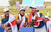 Austrian Sepp Straka lifts the Ryder Cup watched by two of his team-mates, Justin Rose and Tyrrell Hatton, after Europe's victory at Marco Simone Golf and Country Club in Rome. Picture: Andreas Solaro/AFP via Getty Images.