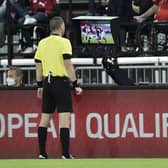 Referee Georgi Kabakov checks the VAR monitor before awarding a penalty to Scotland during the World Cup qualifier in Austria last month