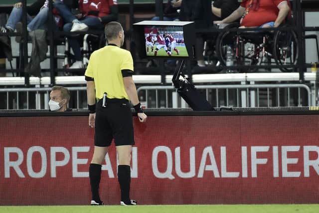 Referee Georgi Kabakov checks the VAR monitor before awarding a penalty to Scotland during the World Cup qualifier in Austria last month