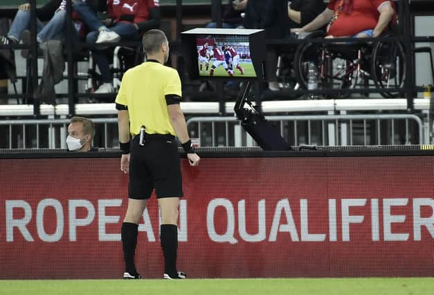 Referee Georgi Kabakov checks the VAR monitor before awarding a penalty to Scotland during the World Cup qualifier in Austria last month