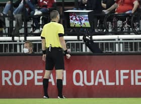 Referee Georgi Kabakov checks the VAR monitor before awarding a penalty to Scotland during the World Cup qualifier in Austria last month