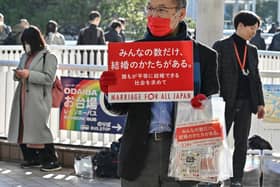 A participant holds up a placard as members of the LGBTQ community and supporters raise awareness on marriage equality in Japan on Valentine's Day in Tokyo this year. Picture: AFP via Getty Images