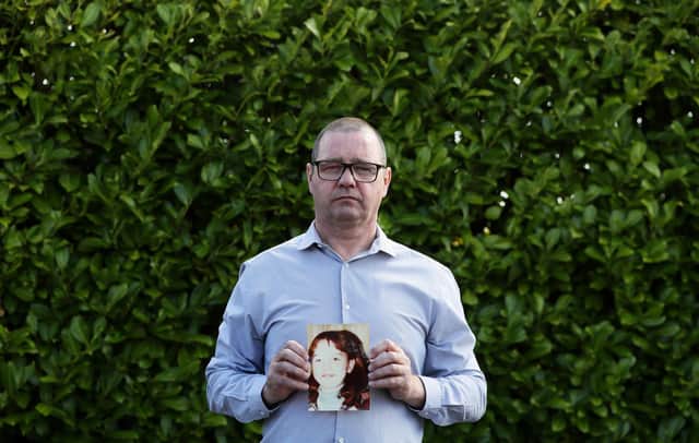 Mark Kelly holds a photograph of his 12-year-old sister Carol-Ann who he saw die after being struck by a plastic bullet in Belfast in 1981 (Picture: Brian Lawless/PA)
