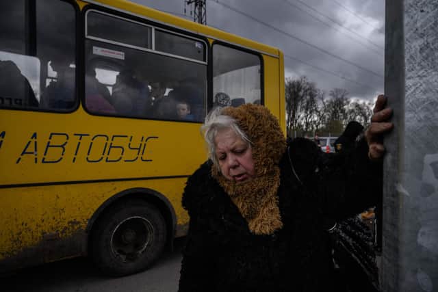 People fleeing fighting in the southern city of Mariupol meet with relatives and friends as they arrive in a small convoy after the opening of a humanitarian corridor, at a registration center for internally displaced people in Zaporizhzhia on April 21, 2022. (Photo by Ed JONES / AFP) (Photo by ED JONES/AFP via Getty Images)