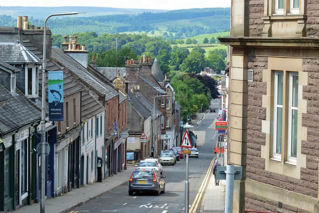 A view down King Street in Crieff, Perthshire, Scotland, past the solid sandstone Burgh Chambers with the green farmland of Strathearn in the distance.