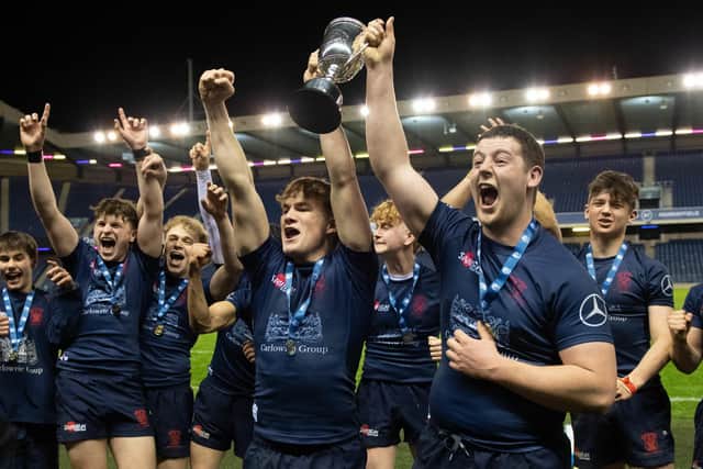 Merchiston's players celebrate with the trophy after defeating Stewart's Melville in the the Scottish Rugby Boys Schools U18 Cup final at BT Murrayfield. (Photo by Ross Parker / SNS Group)