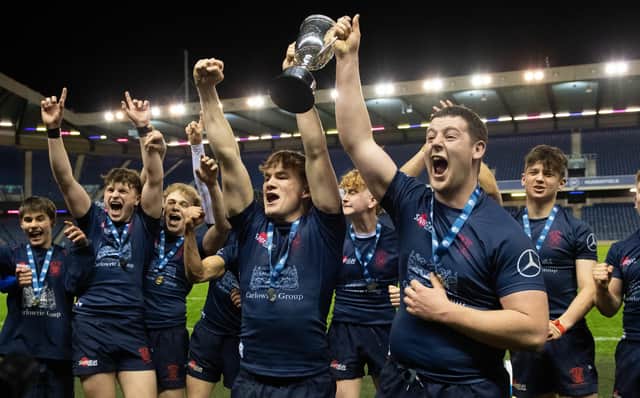Merchiston's players celebrate with the trophy after defeating Stewart's Melville in the the Scottish Rugby Boys Schools U18 Cup final at BT Murrayfield. (Photo by Ross Parker / SNS Group)