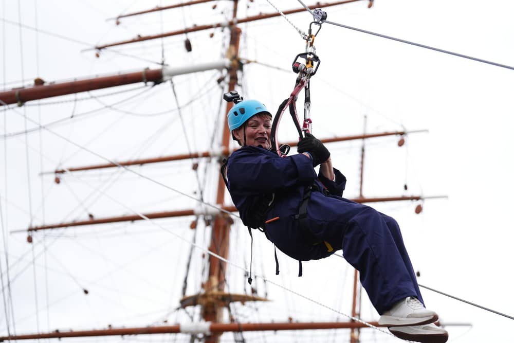 Lorraine Kelly abseils from the mast of the RRS Discovery at Discovery Point in Dundee. Picture: Andrew Milligan/PA Wire