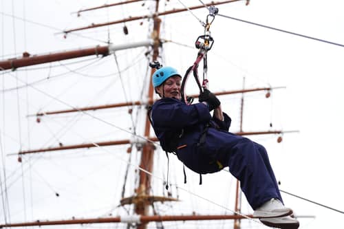 Lorraine Kelly abseils from the mast of the RRS Discovery at Discovery Point in Dundee. Picture: Andrew Milligan/PA Wire