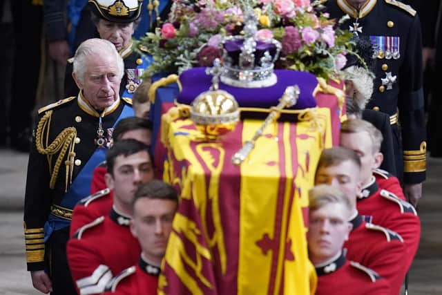 King Charles III and members of the royal family follow behind the coffin of Queen Elizabeth II, draped in the Royal Standard with the Imperial State Crown and the Sovereign's orb and sceptre, as it is carried out of Westminster Abbey after her State Funeral. Picture date: Monday September 19, 2022.