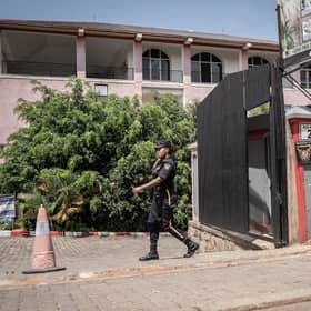 A security officer passes in front of the Desir Resort hotel in Kigali, Rwanda, which is preparing to house migrants.