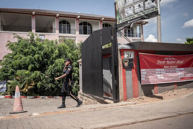 A security officer passes in front of the Desir Resort hotel in Kigali, Rwanda, which is preparing to house migrants.