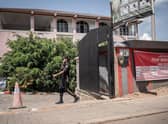 A security officer passes in front of the Desir Resort hotel in Kigali, Rwanda, which is preparing to house migrants.