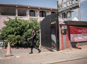 A security officer passes in front of the Desir Resort hotel in Kigali, Rwanda, which is preparing to house migrants.