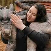 Dragon trainer Laura with one of the realistic dragon puppets which will be heading to Aden.