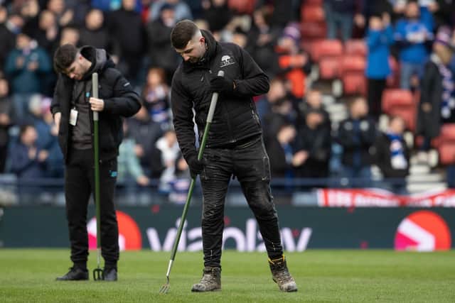 Groundsmen work on the Hampden Park pitch before the Viaplay Cup Semi Final match between Rangers and Aberdeen. (Photo by Alan Harvey / SNS Group)