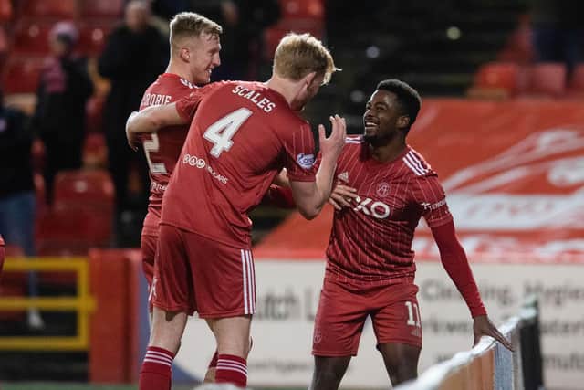 Aberdeen forward Duk is mobbed by his team-mates after scoring a brace in the 2-0 win over St Johnstone at Pittodrie.