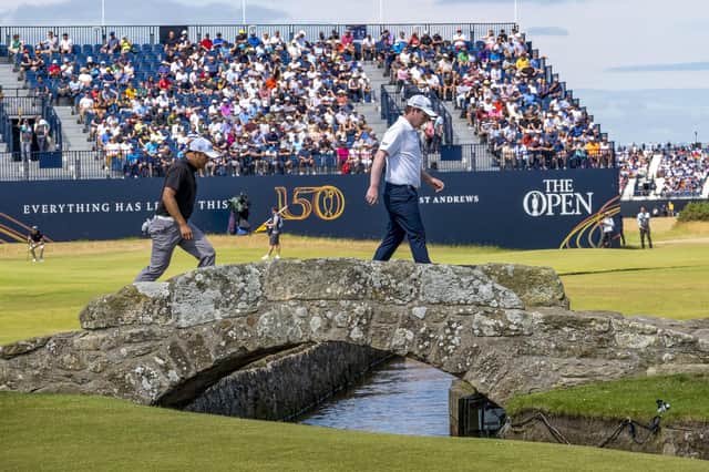 Bob MacIntyre crosss over the Swilcan Bridge with playing partner Justin De Los Santos on his way to the 18th green during the third round of the 150th Open at St Andrews. Picture: Ian Rutherford.