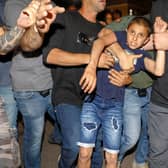 Israeli police detain a boy as Israeli Arabs and left-wing Israelis protest against the purchase of houses in Jaffa, near Tel Aviv by a Jewish religious institution (Picture: Ahmad Gharabli/AFP via Getty Images)