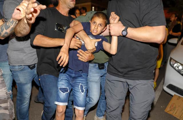 Israeli police detain a boy as Israeli Arabs and left-wing Israelis protest against the purchase of houses in Jaffa, near Tel Aviv by a Jewish religious institution (Picture: Ahmad Gharabli/AFP via Getty Images)