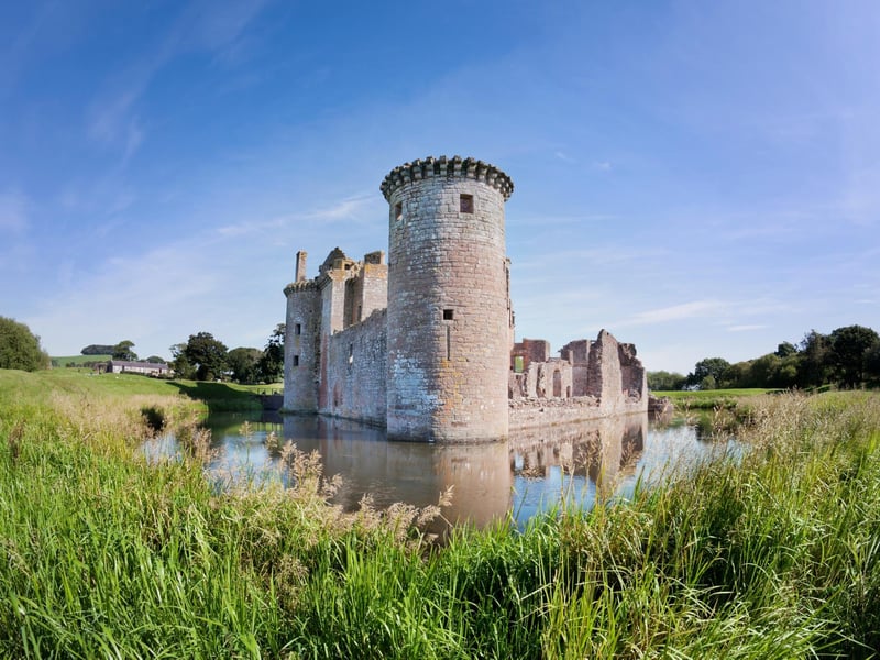 With its moat, twin towered gatehouse and battlements this castle can be thought of as very traditional but it is considered 'unique' to some on account of its triangular shape. It can be found east of the Scottish Borders in Dumfries.