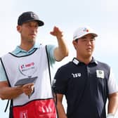 Tom Kim talks with his caddie during the first round of the Hero World Challenge at Albany Golf Course in Nassau, Bahamas. Picture: Mike Ehrmann/Getty Images.