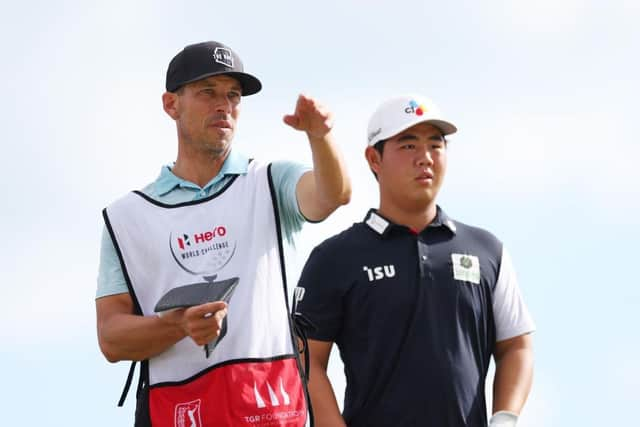 Tom Kim talks with his caddie during the first round of the Hero World Challenge at Albany Golf Course in Nassau, Bahamas. Picture: Mike Ehrmann/Getty Images.