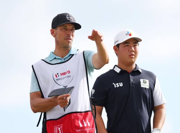 Tom Kim talks with his caddie during the first round of the Hero World Challenge at Albany Golf Course in Nassau, Bahamas. Picture: Mike Ehrmann/Getty Images.