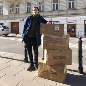Glasgow University graduate Oleksii Rudenko with some boxes of equipment.