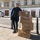 Glasgow University graduate Oleksii Rudenko with some boxes of equipment.