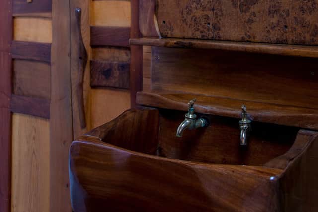The Steading features hand-crafted fixtures and fittings throughout, including this wooden basin in the bathroom