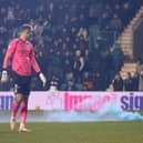 Matt Macey watches as a smoke billows from a canister thrown onto the pitch at Easter Road  (Photo by Craig Foy / SNS Group)