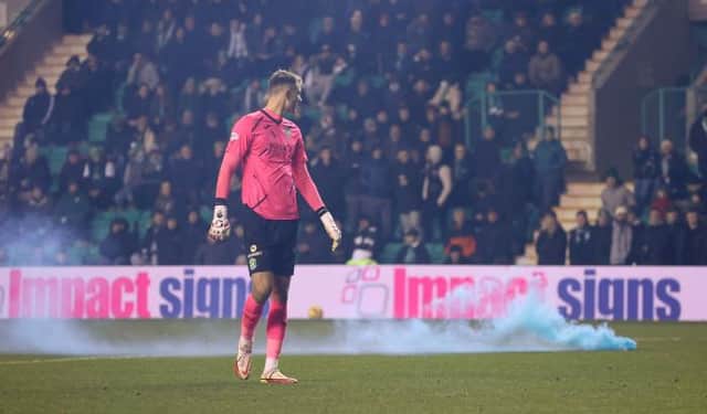 Matt Macey watches as a smoke billows from a canister thrown onto the pitch at Easter Road  (Photo by Craig Foy / SNS Group)