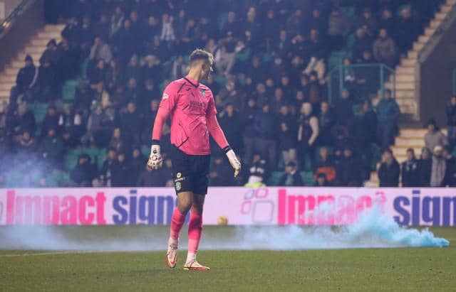 Matt Macey watches as a smoke billows from a canister thrown onto the pitch at Easter Road  (Photo by Craig Foy / SNS Group)