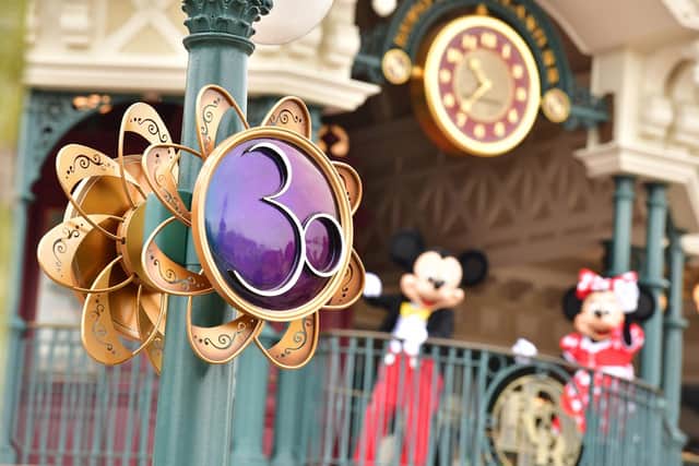 Mickey and Minnie on the balcony of Disneyland Railroad Main Street Station at Disneyland Paris with 30th anniversary decor in the foreground. Pic: PA Photo/Disney/Valentin Desjardins.