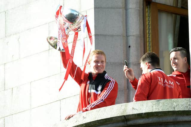 Robson won the League Cup as a player for the Dons in 2014.