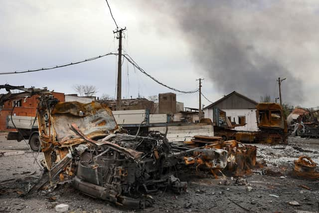 Burned vehicles are seen at the destroyed part of the Illich Iron & Steel Works Metallurgical Plant, as smoke rises from the Metallurgical Combine Azovstal during heavy fighting, in an area controlled by Russian-backed separatist forces in Mariupol, Ukraine.