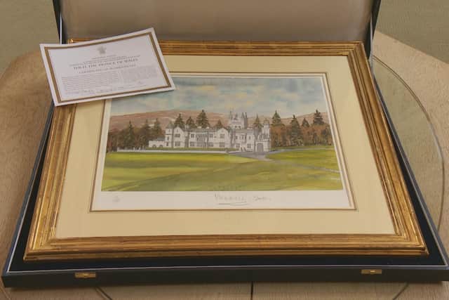 A watercolour print of Balmoral Castle by King Charles, signed 'Charles 2001'. 