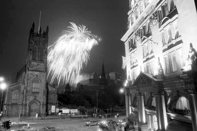 The Glenlivet Festival Fireworks concert in August 1985 - fireworks burst over St John's church and Edinburgh Castle with the Caledonian Hotel to the right.