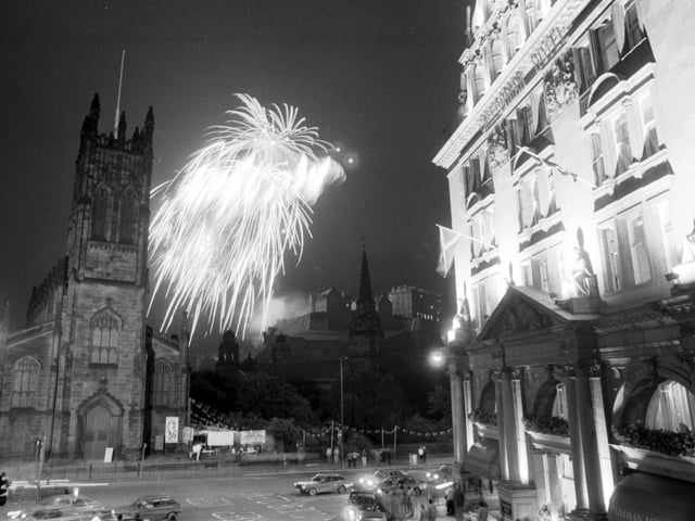 The Glenlivet Festival Fireworks concert in August 1985 - fireworks burst over St John's church and Edinburgh Castle with the Caledonian Hotel to the right.