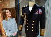 Kate Braun, curator at the National Museum of the Royal Navy, looks at a naval uniform which once belonged to the Duke of Edinburgh