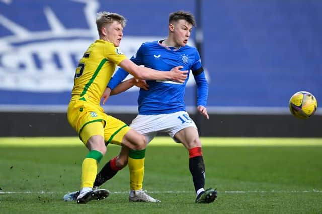 Hibernian left-back Josh Doig and Rangers right-back Nathan Patterson tussle during a match at Ibrox in April. Both have been shortlisted for the SFWA Young Player of the Year award. (Photo by Rob Casey / SNS Group)