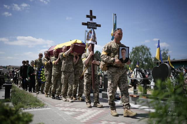 Ukrainian soldiers carry the coffin of Roman Tkachenko, 21, who was killed fighting the Russian invasion near Kharkiv earlier this month (Picture: Christopher Furlong/Getty Images)