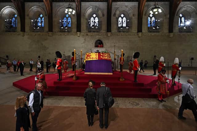 Members of the public file past the the coffin of Queen Elizabeth II, as they pay their respects as the vigil begins in Westminster Hall, London, where it will lie in state ahead of her funeral on Monday. Picture date: Wednesday September 14, 2022.