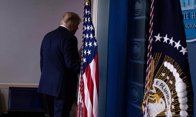 Donald Trump departs the White House press briefing room, just hours before Joe Biden is declared the winner of the US presidential election. (Picture: Brendan Smialowski/AFP/Getty)