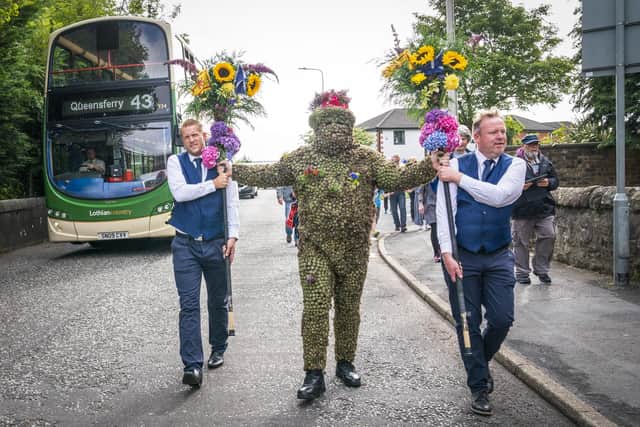 Burryman Andrew Taylor parades through the town of South Queensferry.